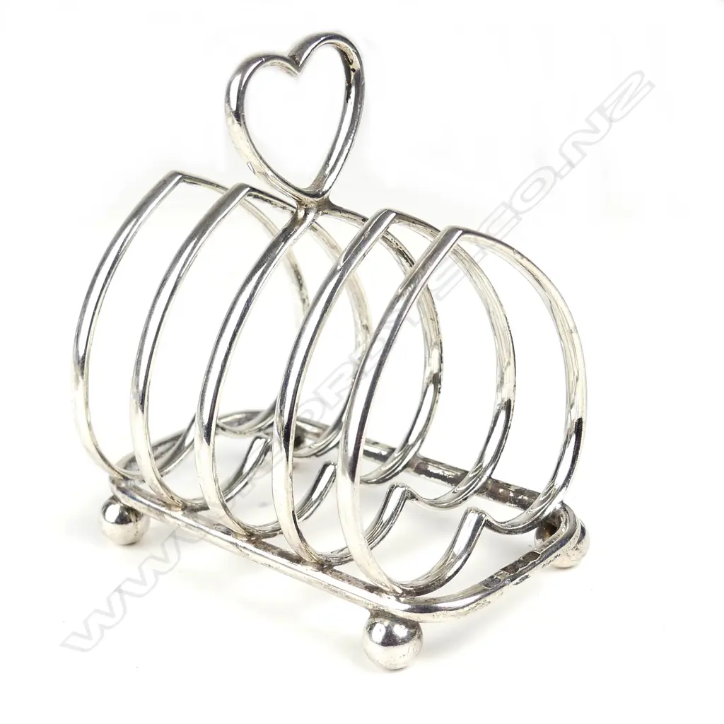 A silver four slice toast rack Image 1++