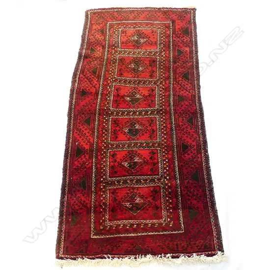 An Afghan Baluchi wool on cotton runner rug