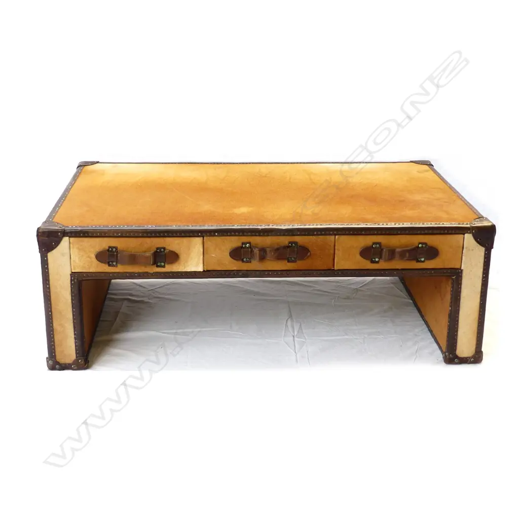 A modern designer pony hide and leather trimmed 'steamer' type coffee table/ottoman Image 1++