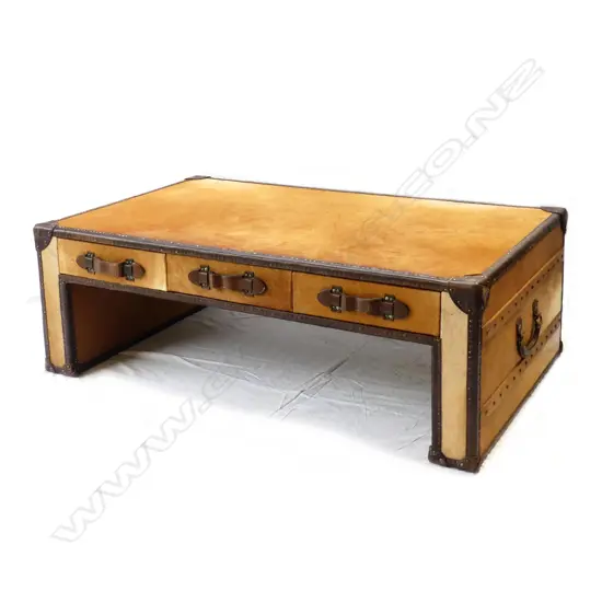 A modern designer pony hide and leather trimmed 'steamer' type coffee table/ottoman