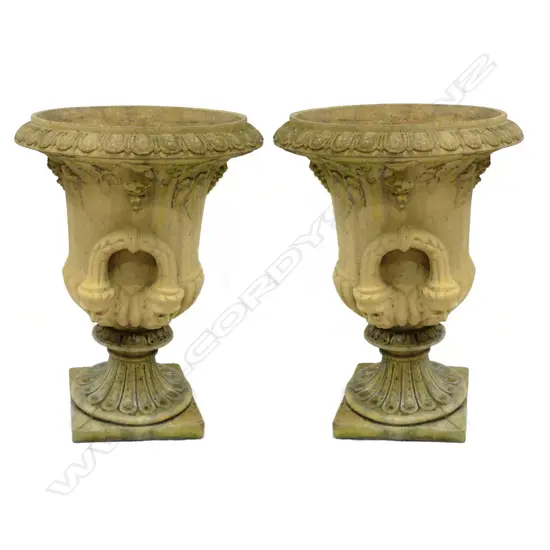 A pair of vintage concrete garden urns