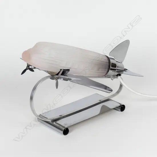A reproduction Art Deco chrome and pink glass aeroplane desk lamp