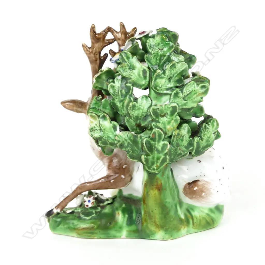 A 19thC porcelain Staffordshire type recumbent deer figure Image 1++