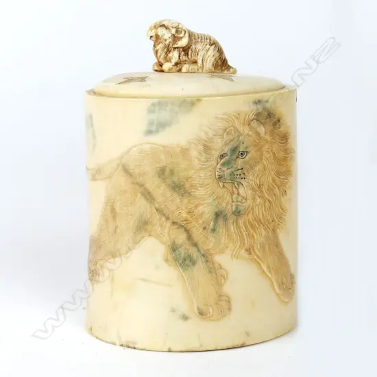 A carved ivory tusk section canister