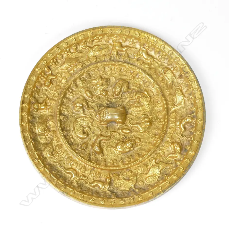 A highly ornate gilded Oriental bronze circular mirror Image 1++