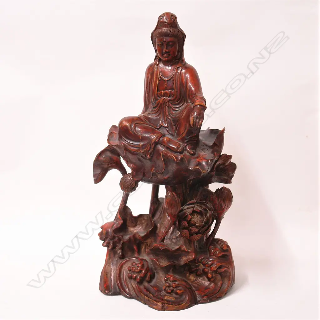 An old Chinese red lacquered carved wood figure of Guanyin raised on an elaborate base Image 1++