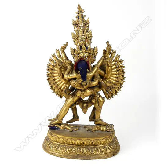 A Tibetan gilt bronze figure of a sixteen headed deity