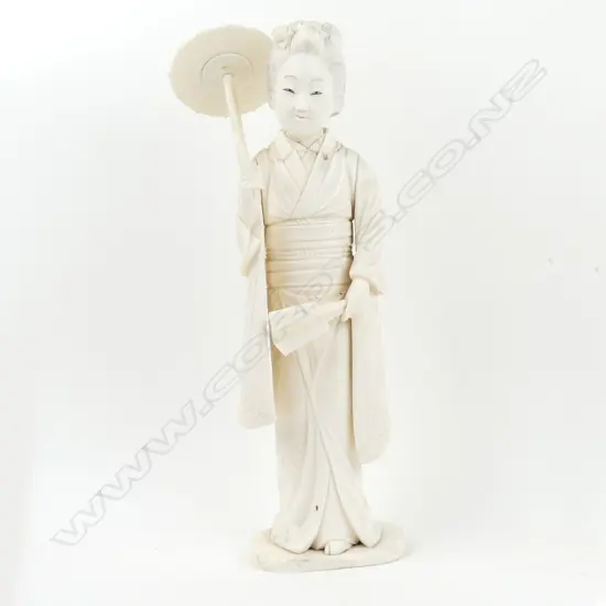 A Japanese bone sectional figure of a woman with parasol and fan