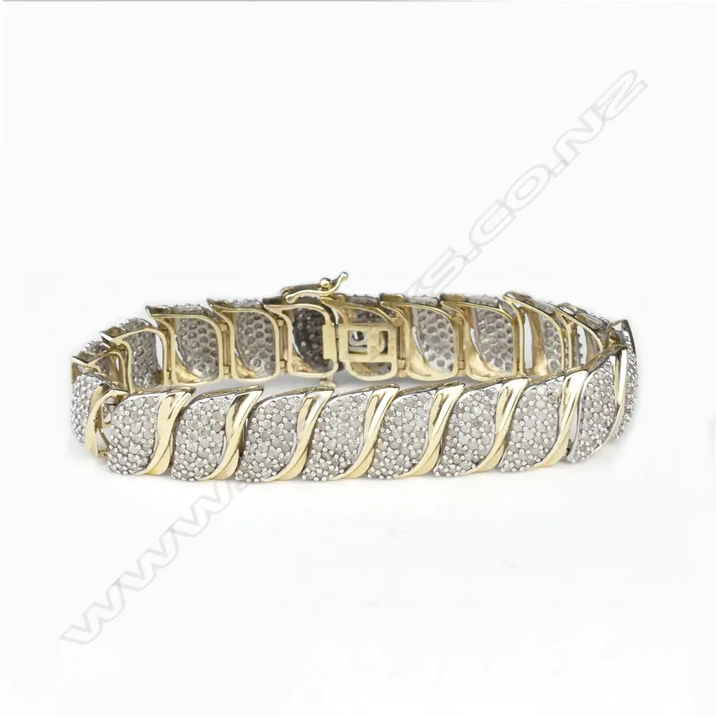 A 10ct yellow gold and multi-diamond set bracelet Image 1++
