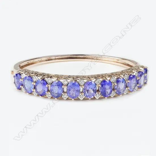 A 14ct rose gold tanzanite and diamond Victorian style hinged bangle
