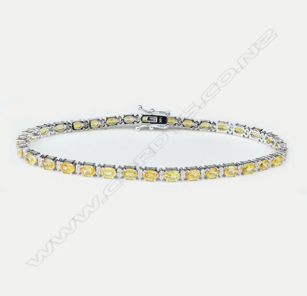 A 14ct white gold diamond and sapphire tennis bracelet Image 1++