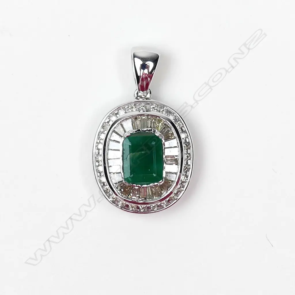 A 9ct white gold emerald and diamond pendant Image 1++
