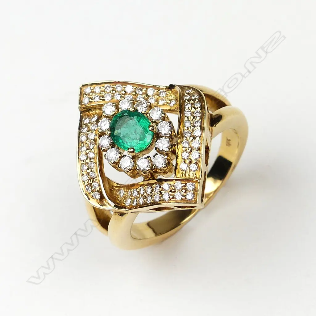An 18ct gold emerald and diamond ring Image 1++
