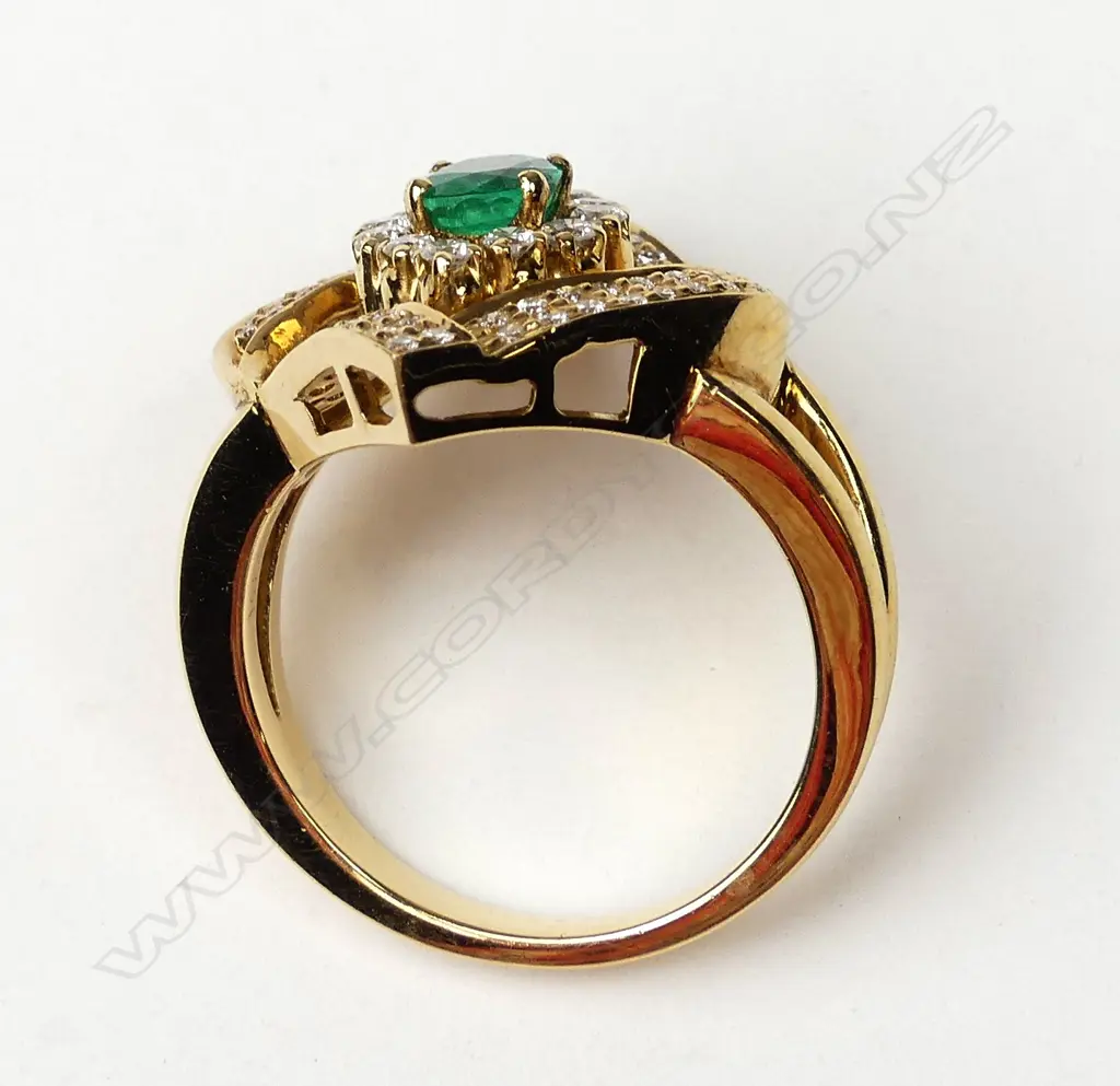 An 18ct gold emerald and diamond ring Image 1++