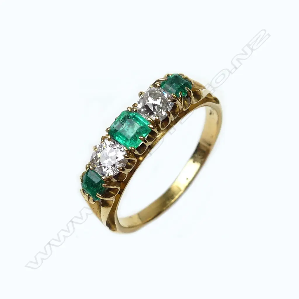 An 18ct gold emerald and diamond ring Image 1++