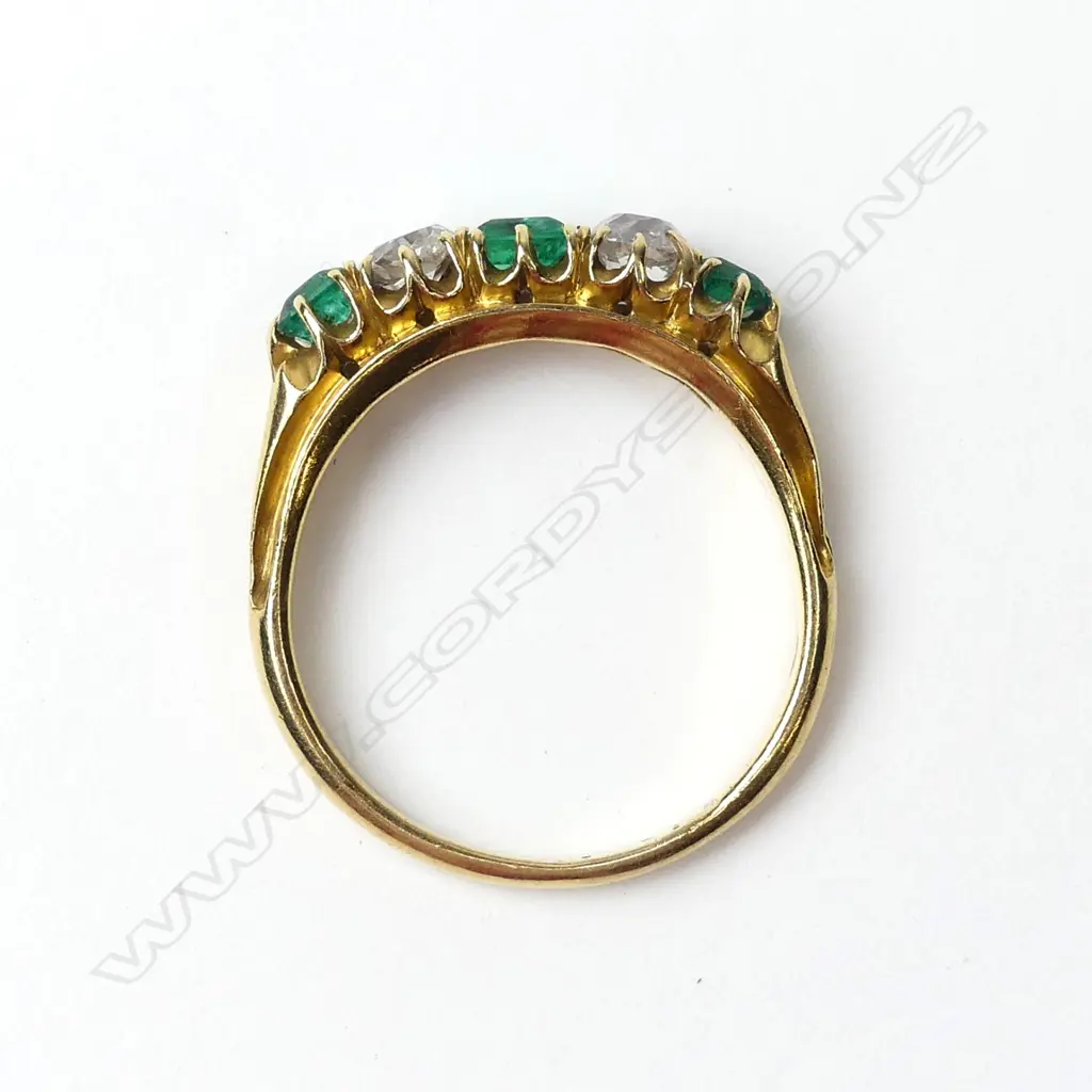 An 18ct gold emerald and diamond ring Image 1++