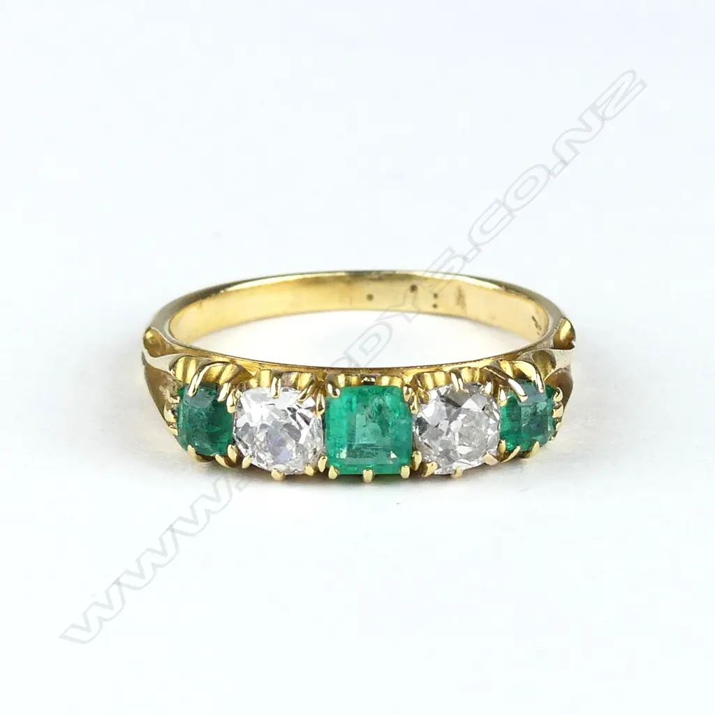 An 18ct gold emerald and diamond ring Image 1++