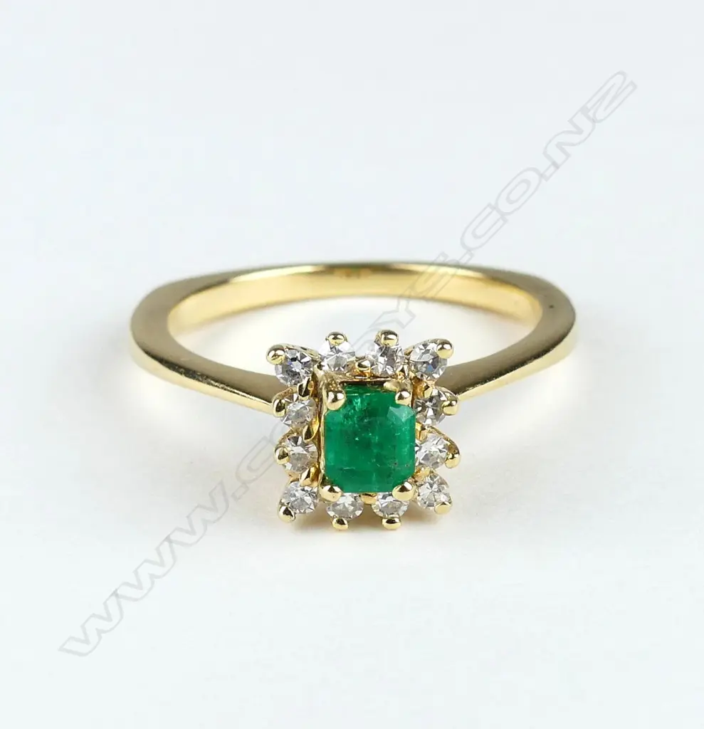 An 18ct gold emerald and diamond ring Image 1++