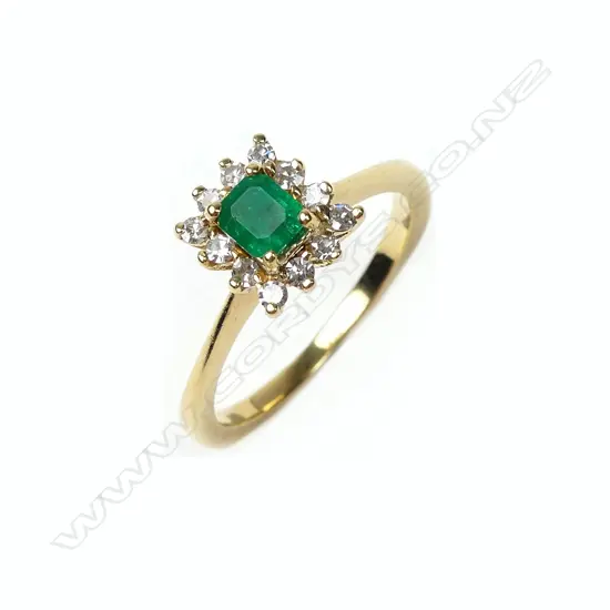 An 18ct gold emerald and diamond ring