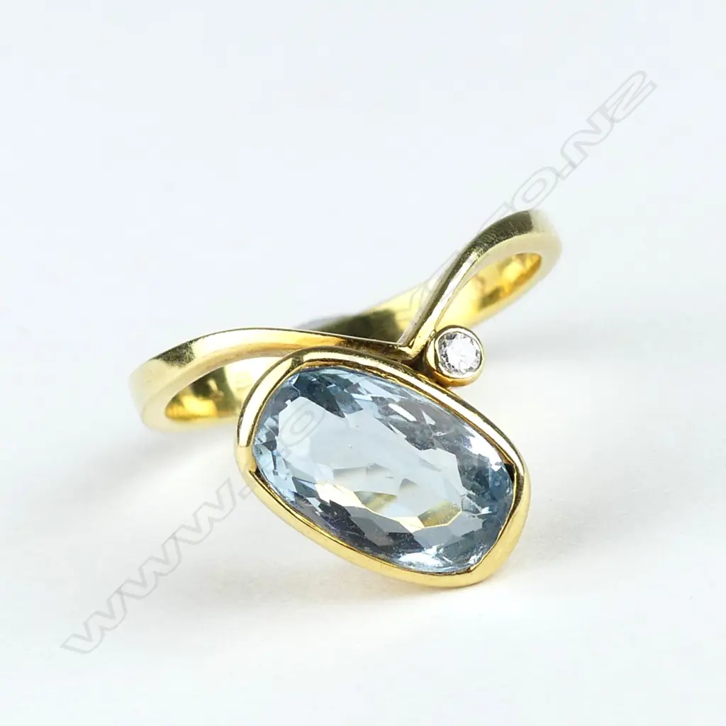 An 18ct gold aquamarine and diamond ring Image 1++