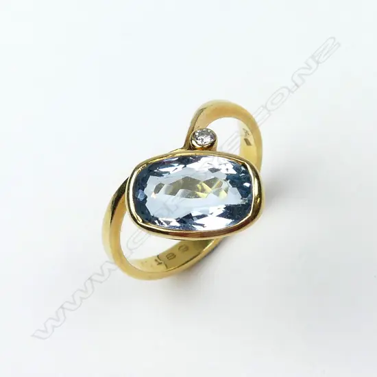 An 18ct gold aquamarine and diamond ring