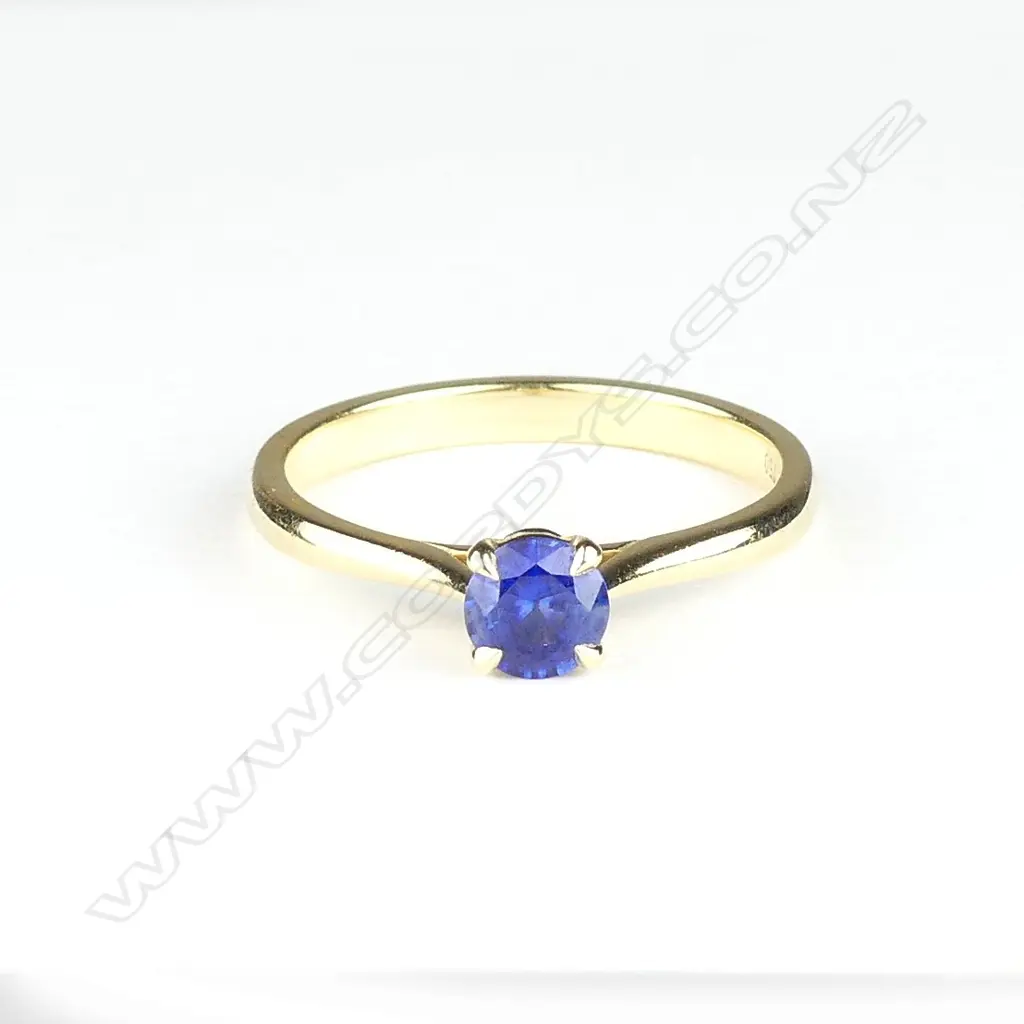 An 18ct gold and sapphire solitaire ring Image 1++