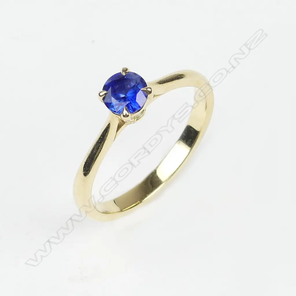 An 18ct gold and sapphire solitaire ring Image 1++