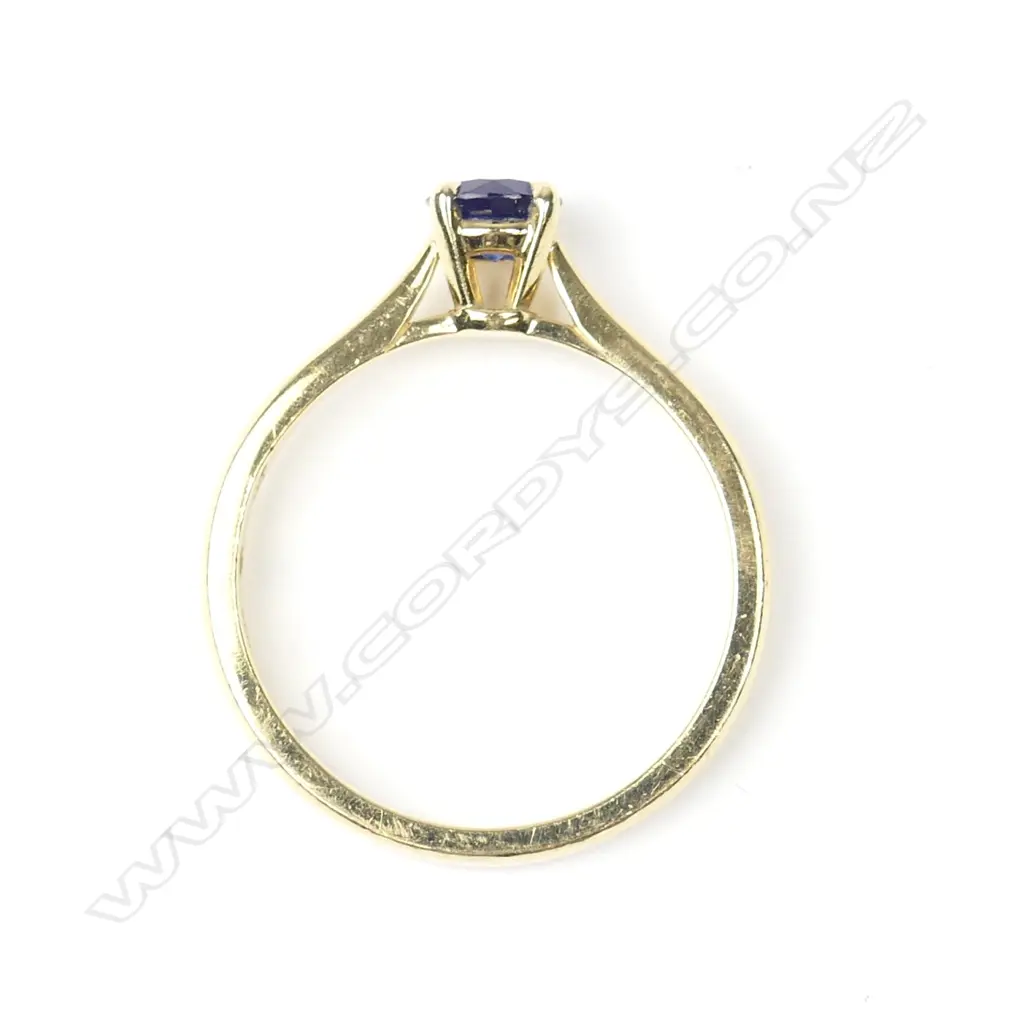 An 18ct gold and sapphire solitaire ring Image 1++