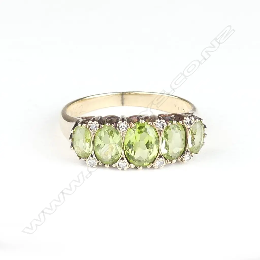 A 9ct gold peridot and diamond ring Image 1++