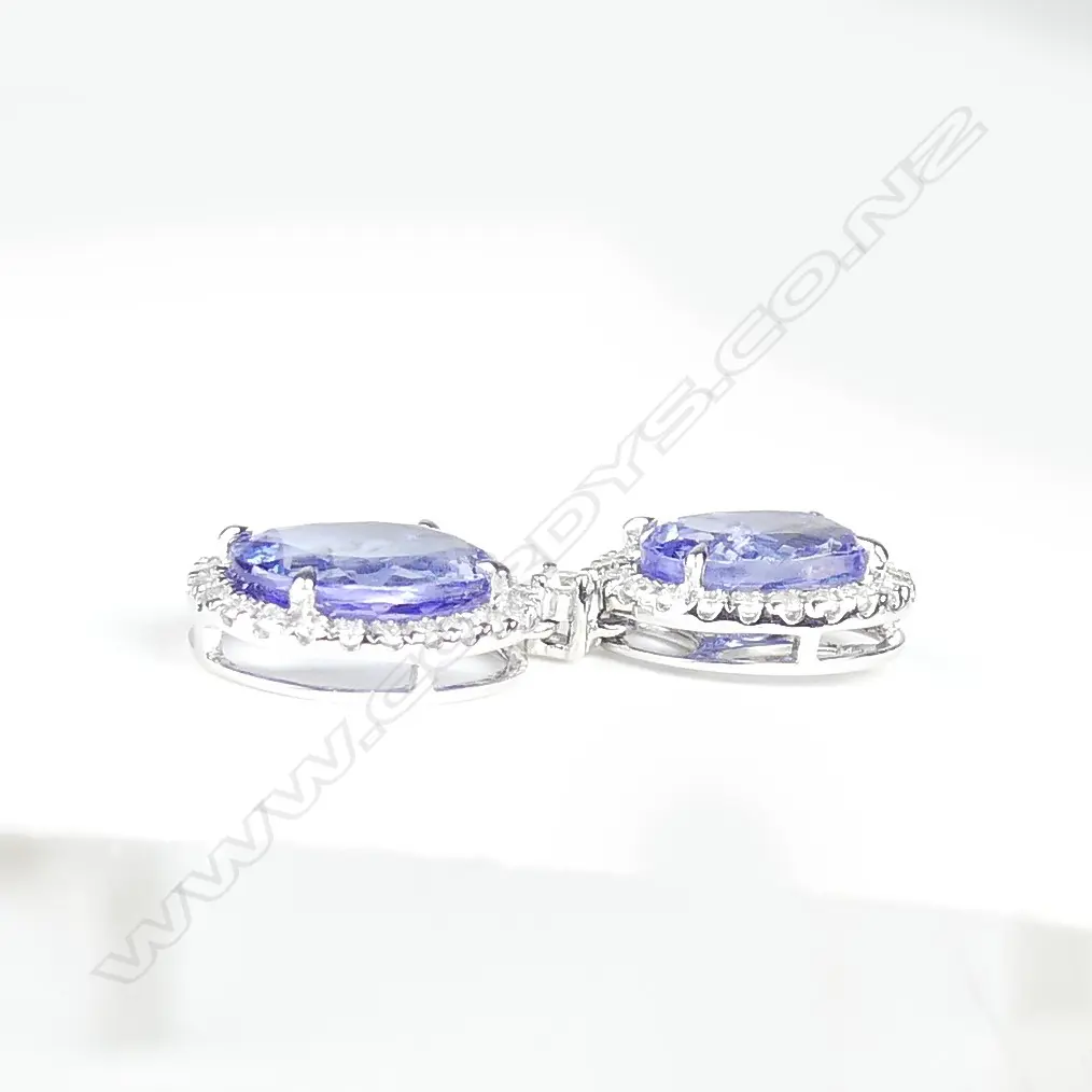 A pair of 14ct white gold tanzanite and diamond drop earrings Image 1++