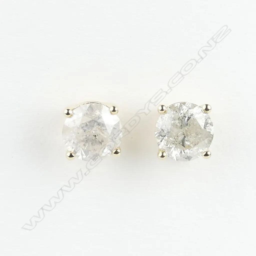 A pair of 14ct gold and diamond stud earrings Image 1++
