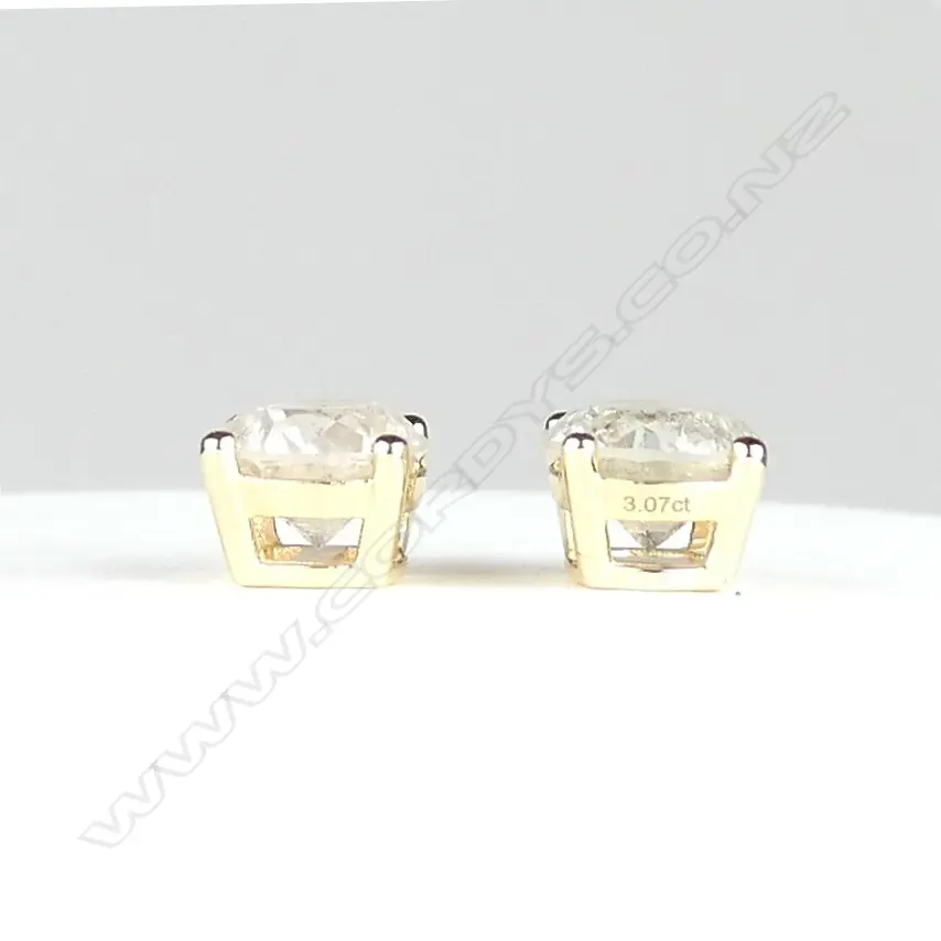 A pair of 14ct gold and diamond stud earrings Image 1++