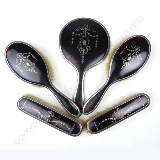 A silver and tortoiseshell pique work dressing table set