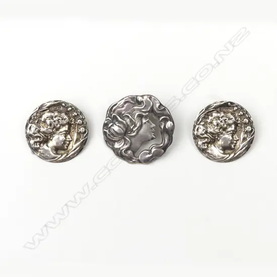 A pair plus one of Edwardian silver Art Nouveau portrait buttons
