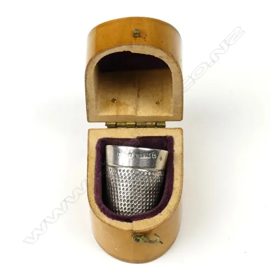 A silver thimble by James Swann & Son
