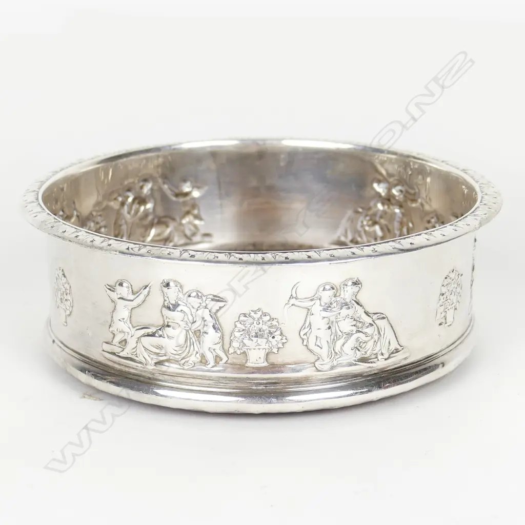 An uncommon George III silver decorated bottle coaster Image 1++