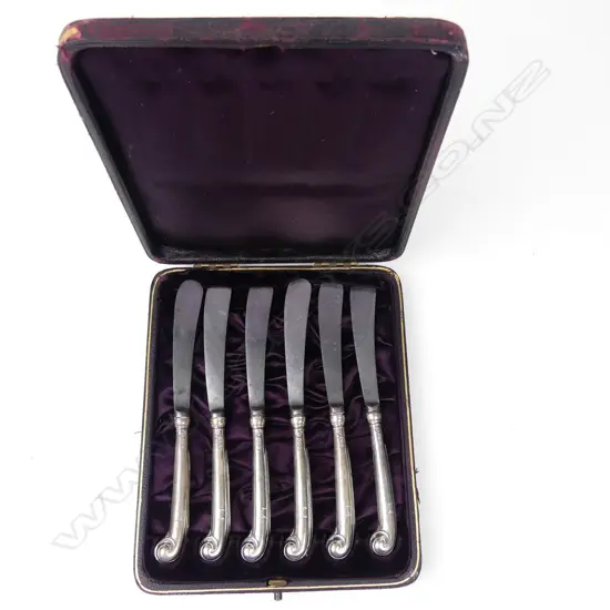 A cased set of six Victorian silver pistol grip handled butter knives