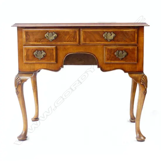 A quality early 20thC figured walnut lowboy