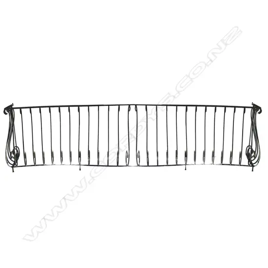 A long vintage scrolling iron long deck balustrade
