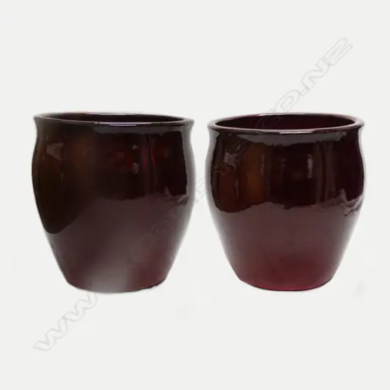 A pair of large flambé red glazed urns
