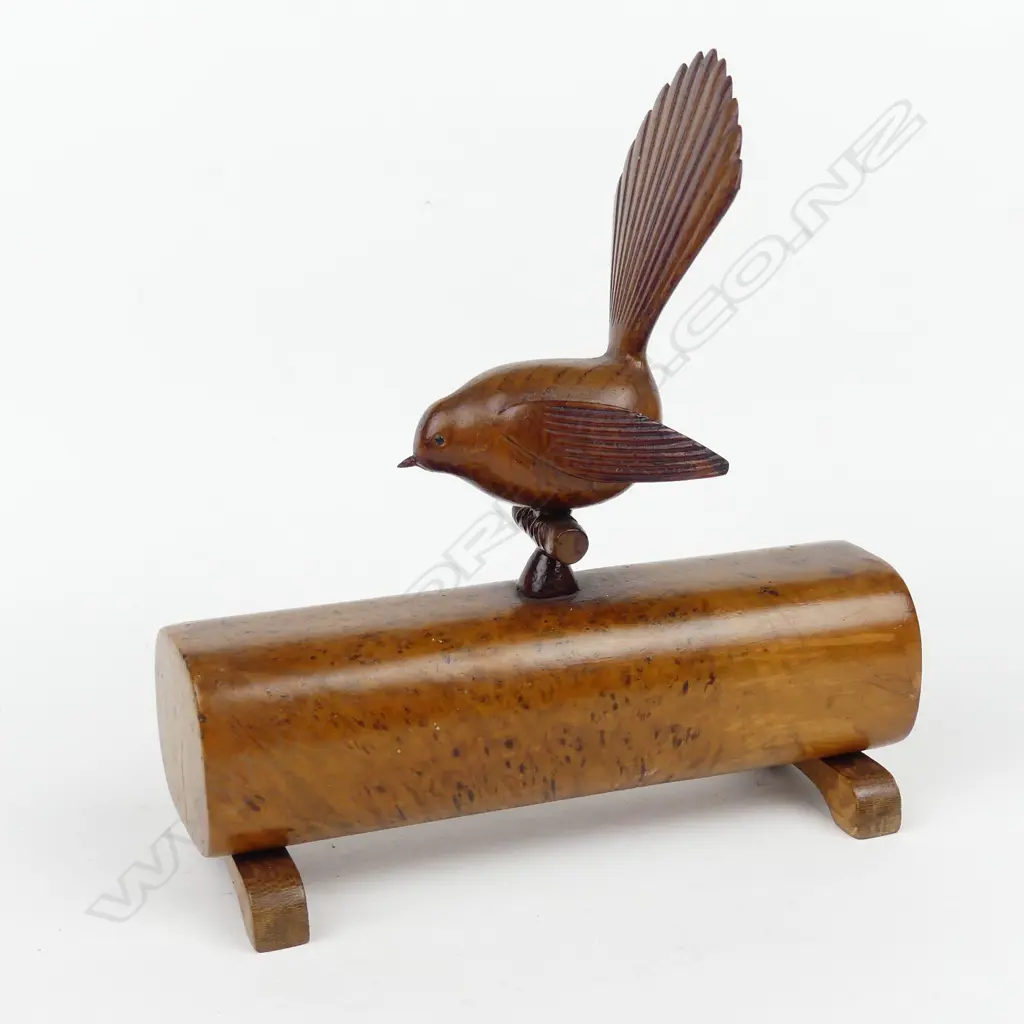 A native timber folk art carving of a fantail on a log Image 1++