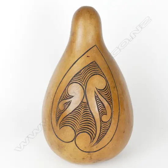 A large gourd carved with Maori kowhaiwhai inspired designs