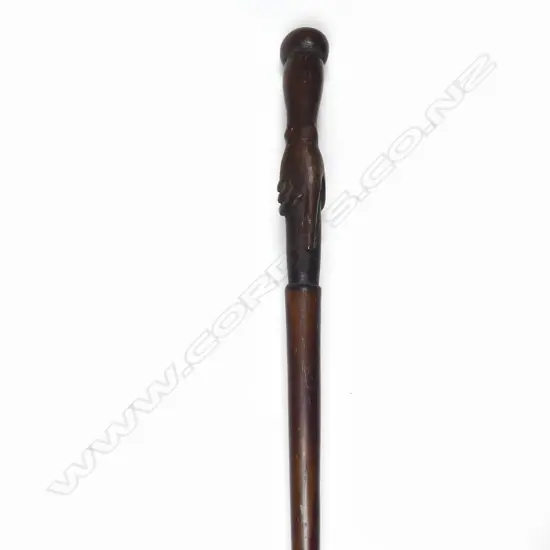 A late 19thC hardwood carved clasped hand handled walking stick