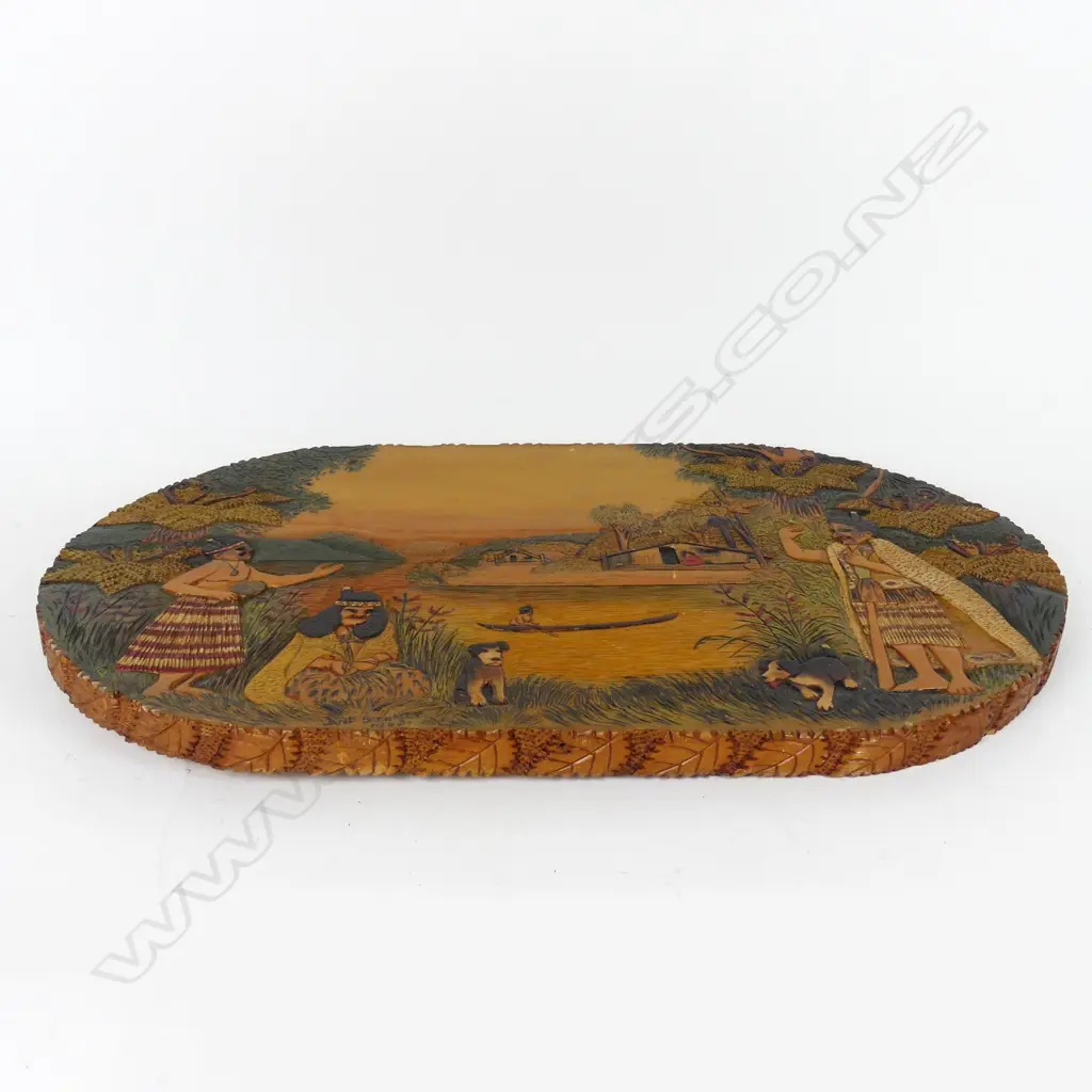 An oval Jane Brenkley carved and painted Maori themed table-top/wall plaque Image 1++