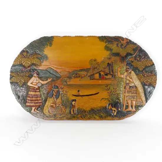 An oval Jane Brenkley carved and painted Maori themed table-top/wall plaque