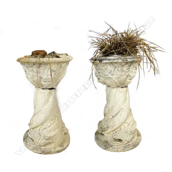A pair of old concrete garden urns