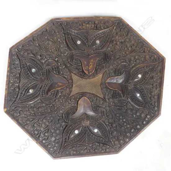 An octagonal carved tabletop
