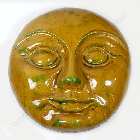 A large ceramic wall mask