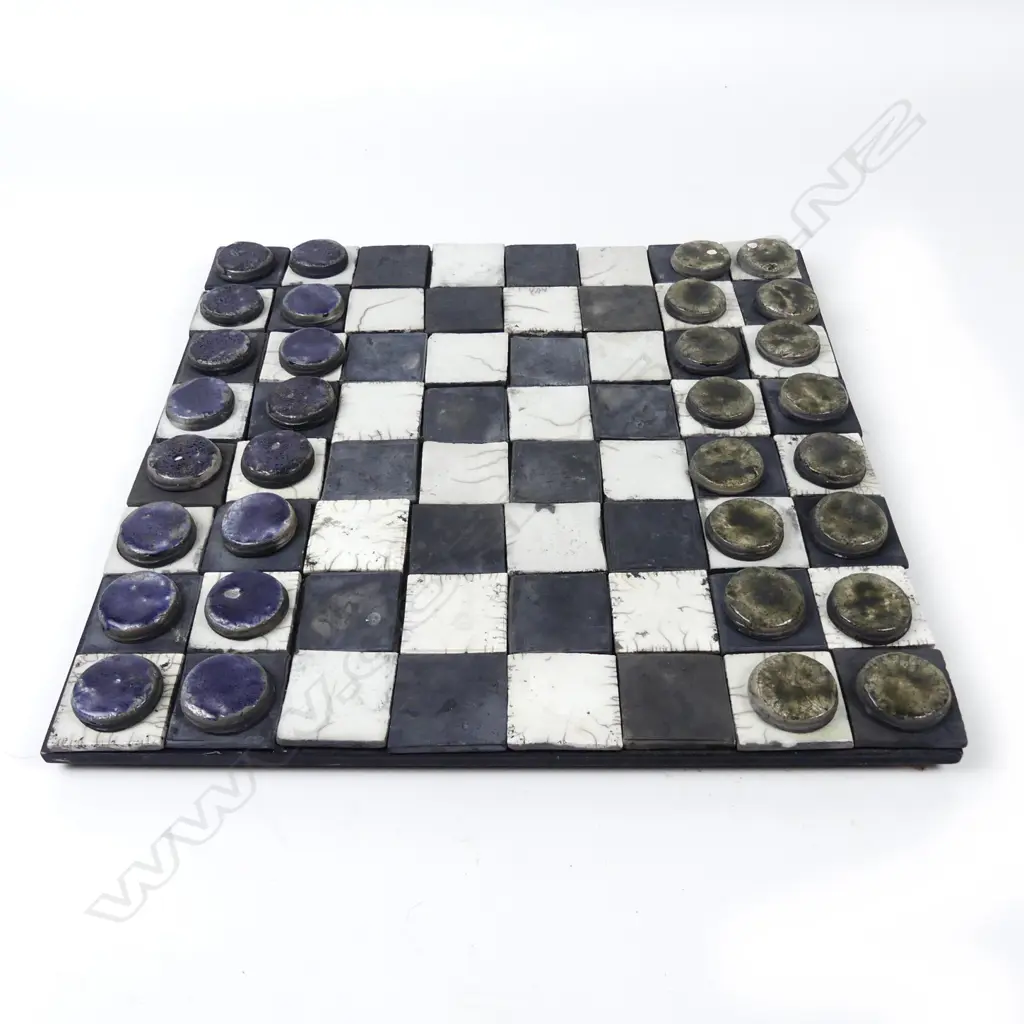 A ceramic draughts/chess board and draughts Image 1++