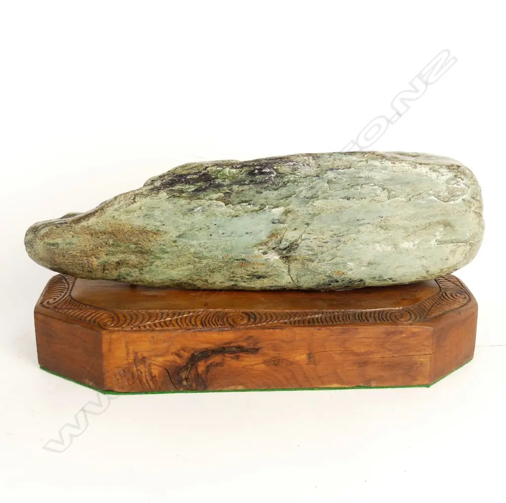 A pounamu boulder fixed to a Maori carved wooden plinth Image 1++
